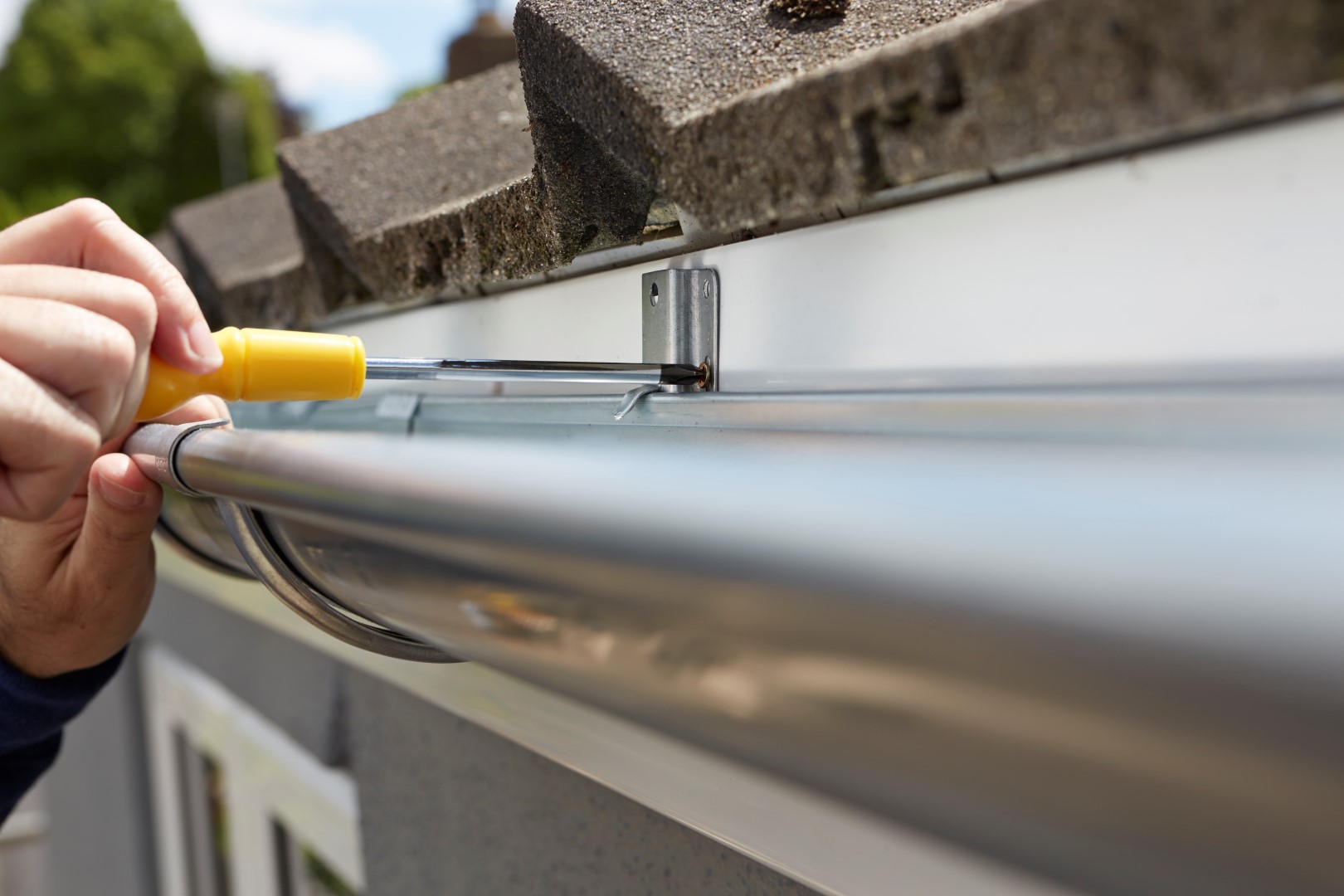 man replacing guttering